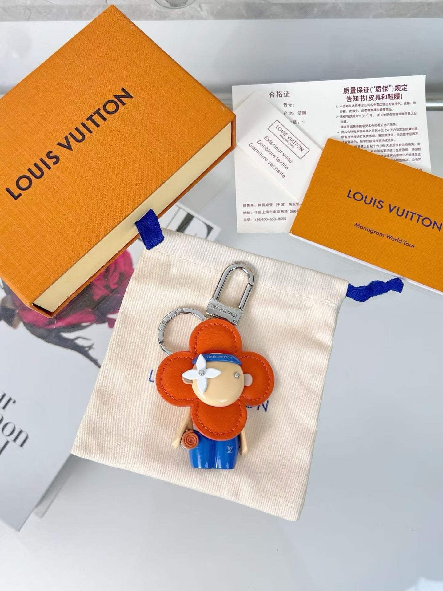 Louis Vuitton Flower Boy Keychain – Orange Head, Blue Cap & Monogram Style
