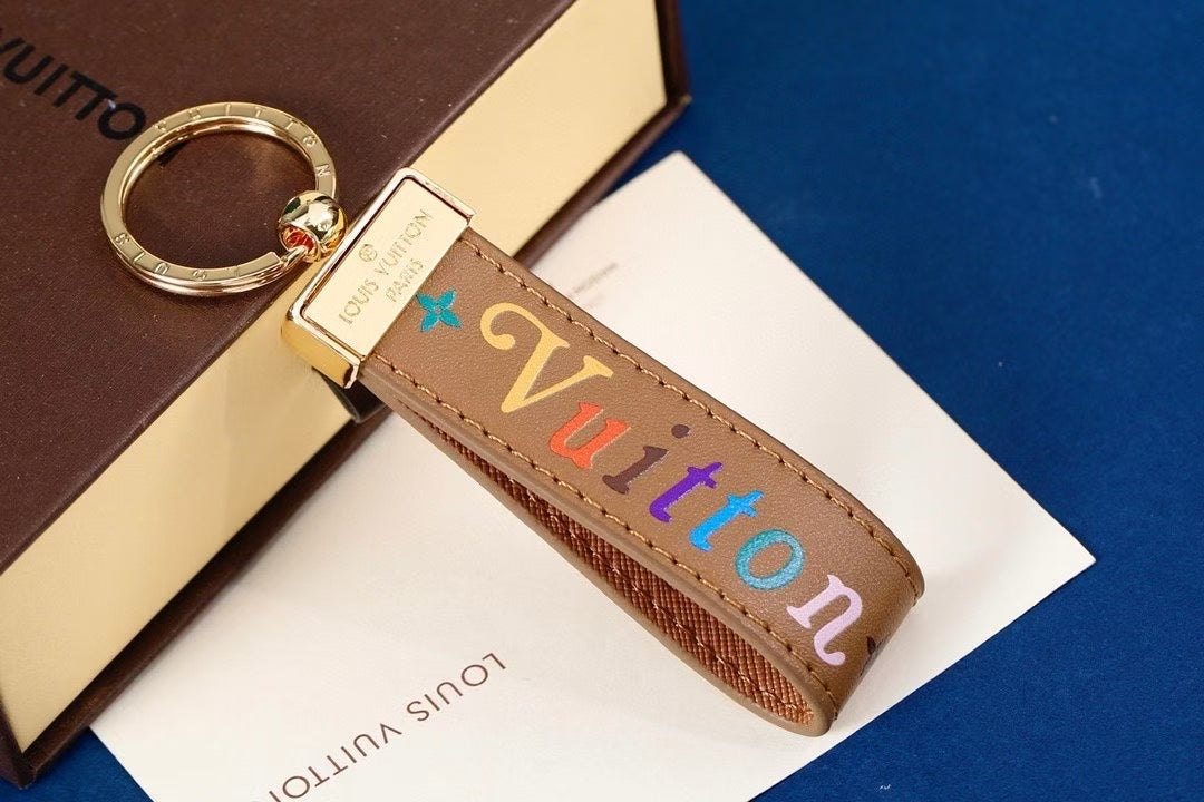 Louis Vuitton Multicolor “Louis” Keychain – Brown, White & Black Leather Straps