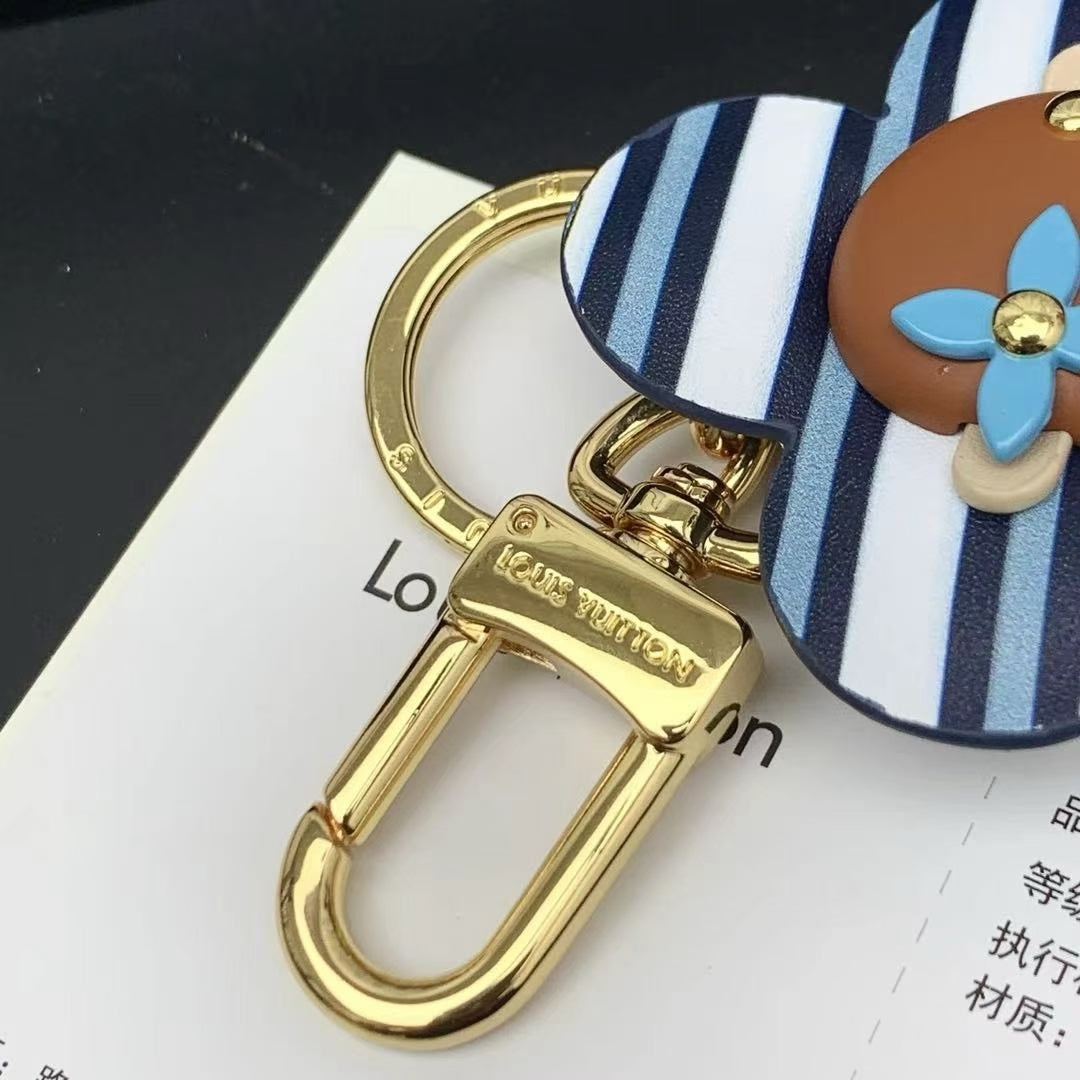 Louis Vuitton Striped Flower Padlock Keychain – Blue & White Petals with Gold Hardware