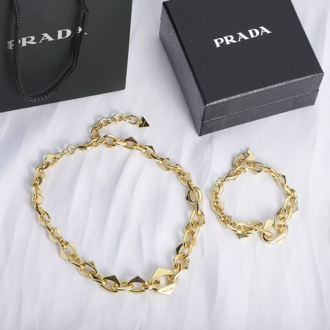 PRADA Heart & Triangle Charm Jewelry Set – Gold Necklace & Bracelet