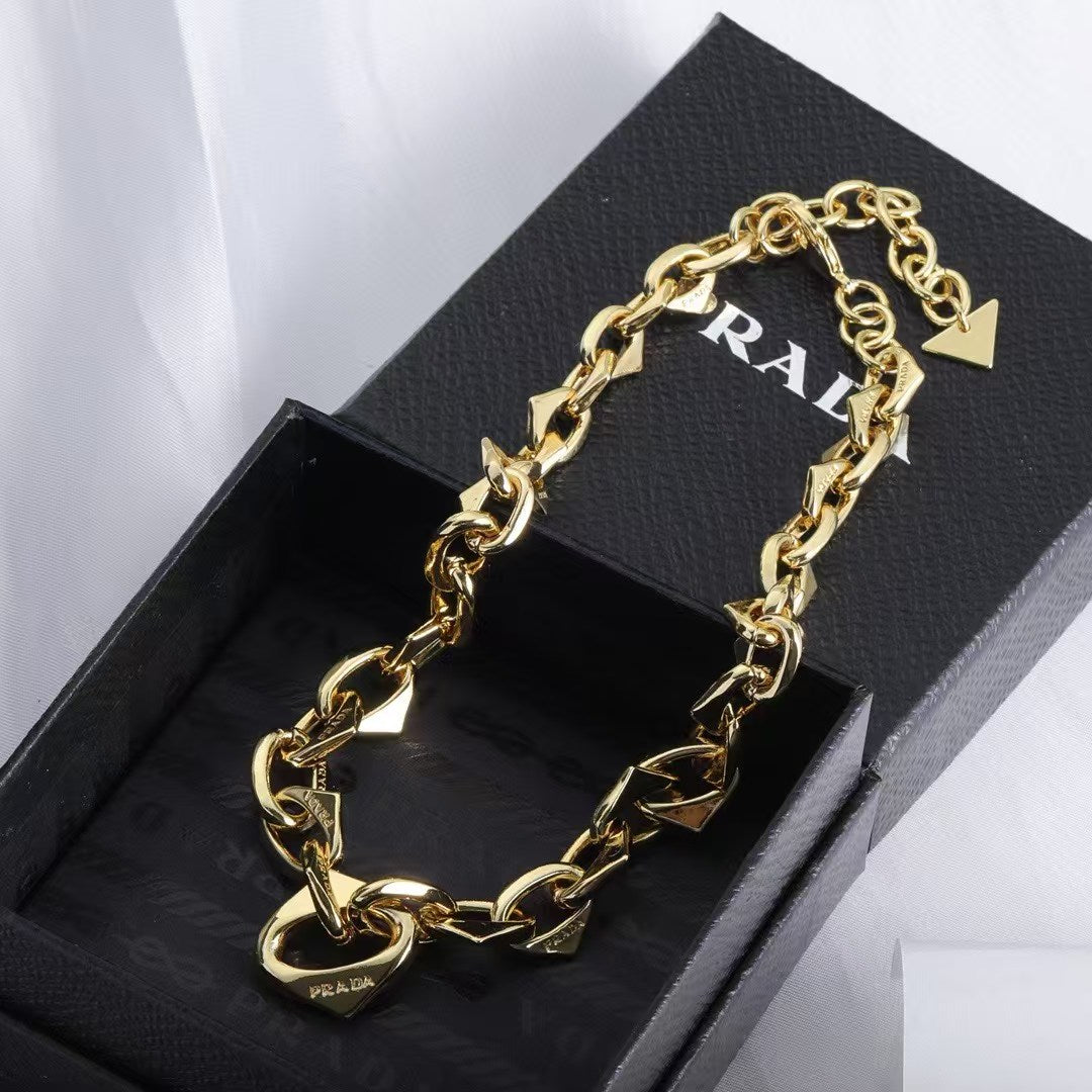 PRADA Heart & Triangle Charm Jewelry Set – Gold Necklace & Bracelet