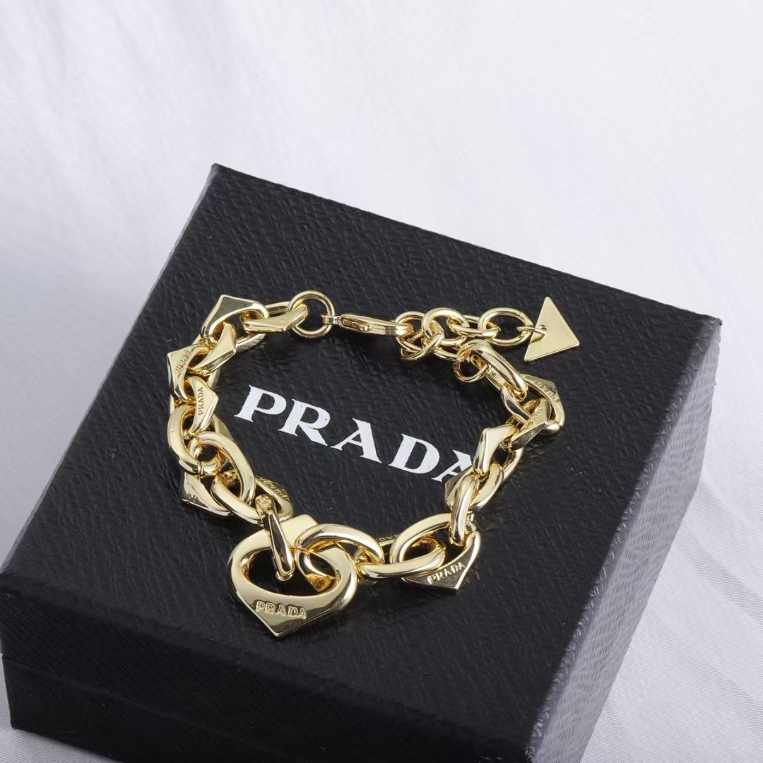 PRADA Heart & Triangle Charm Jewelry Set – Gold Necklace & Bracelet