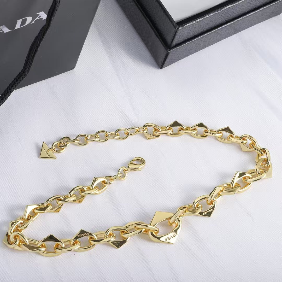 PRADA Heart & Triangle Charm Jewelry Set – Gold Necklace & Bracelet