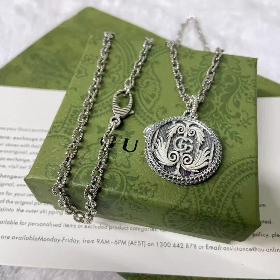 Gucci Silver GG Scroll Pendant Necklace – Ornate Circular Medallion on Textured Chain
