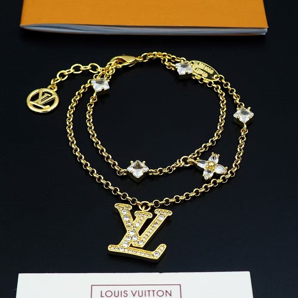 Louis Vuitton Crystal LV Jewelry Set – Gold-Tone Necklace & Bracelet with Sparkling Logo Pendants