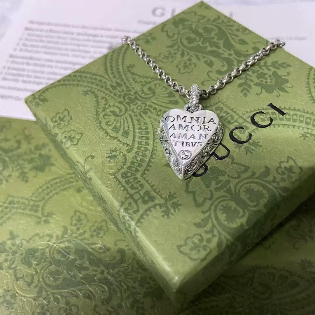 Gucci Heart Pendant Necklace – Sterling Silver with “Omnia Amor Amantibus” Motto
