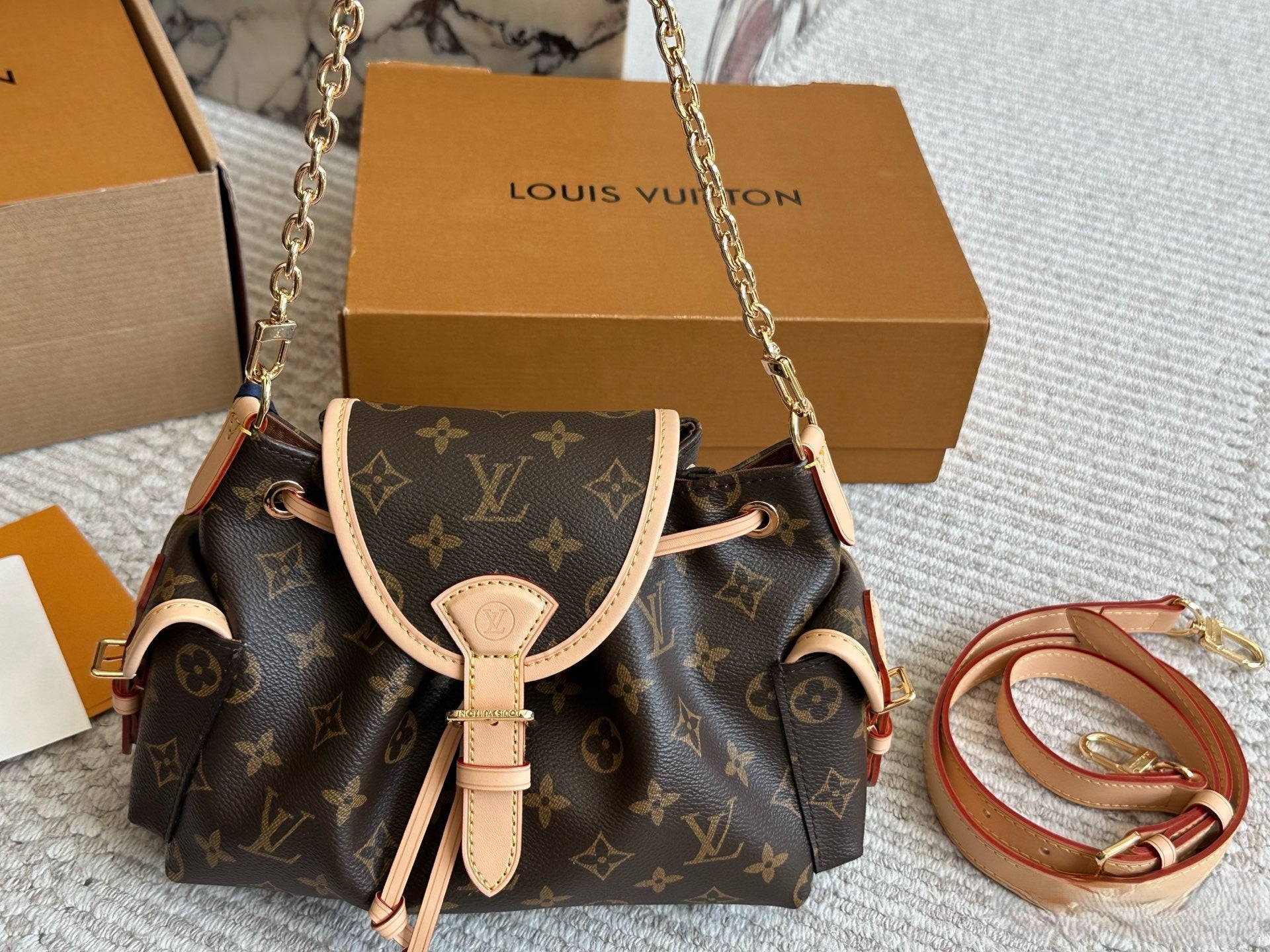 Louis Vuitton Drawstring Flap Handbag with Gold Hardware