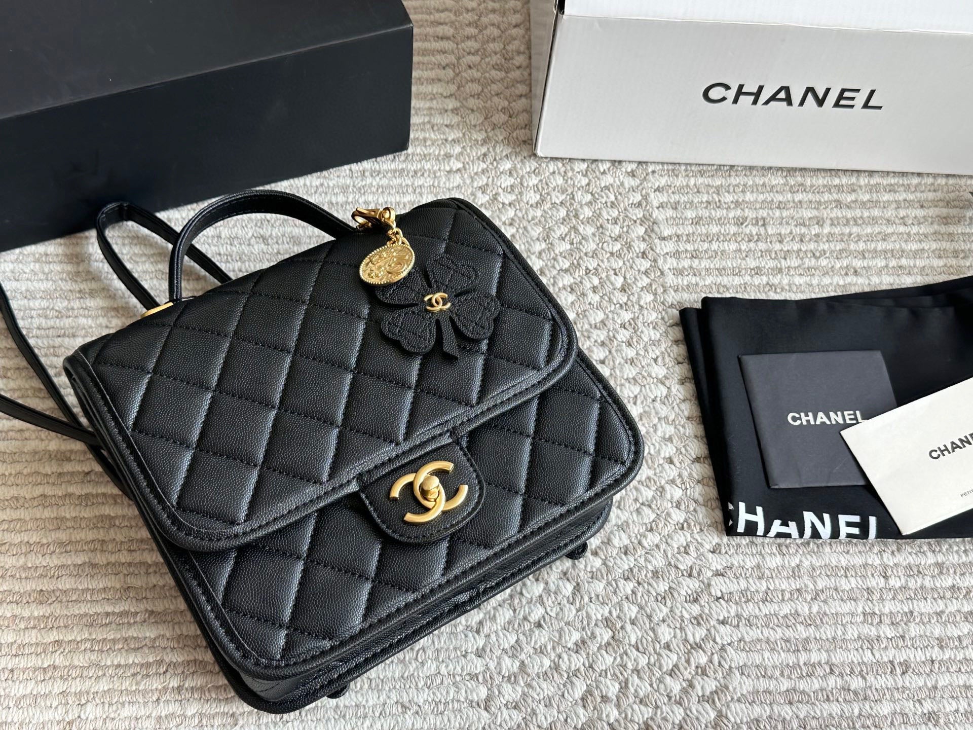 Chanel Quilted Backpack Black Leather with Gold Hardware & Floral Charm