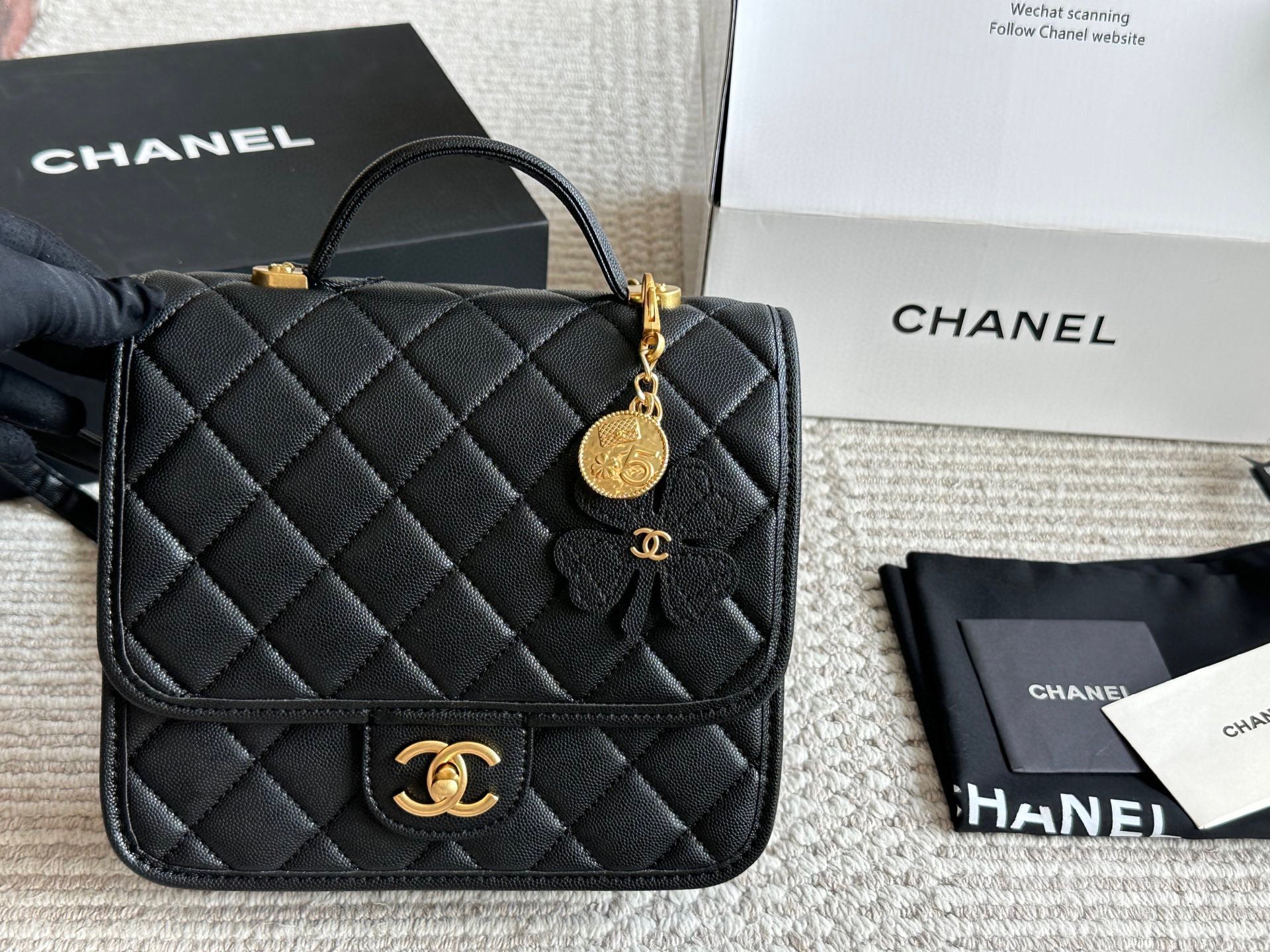 Chanel Quilted Backpack Black Leather with Gold Hardware & Floral Charm
